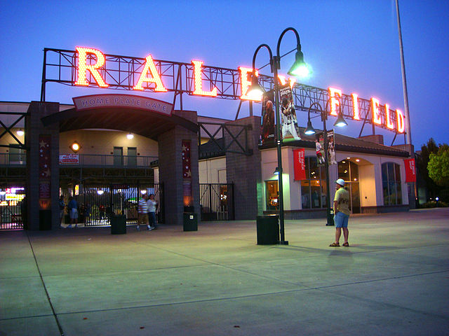 Raley Field - Baseball Field front entrance at night with light up lettering across the top spelling out "RALEY FIELD"