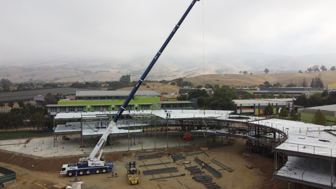 A crane lifting steel beams for JD2 Industrial Steel