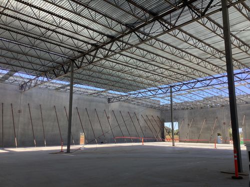 A picture of open web steel joist roofing in a warehouse.