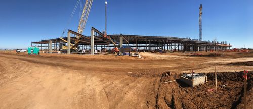 A wide angle shot of the steel frame of the Hardrock Fire Mountain building with a crane and lift in the foreground.