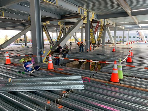 A steel building under construction from inside on one of the levels.