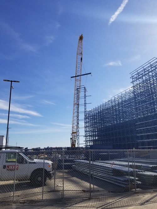 A crane lifting a steel structure into place.