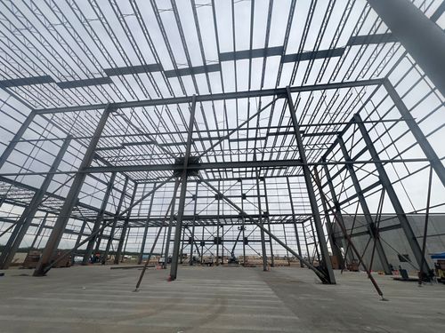 The steel frame of a warehouse under construction.
